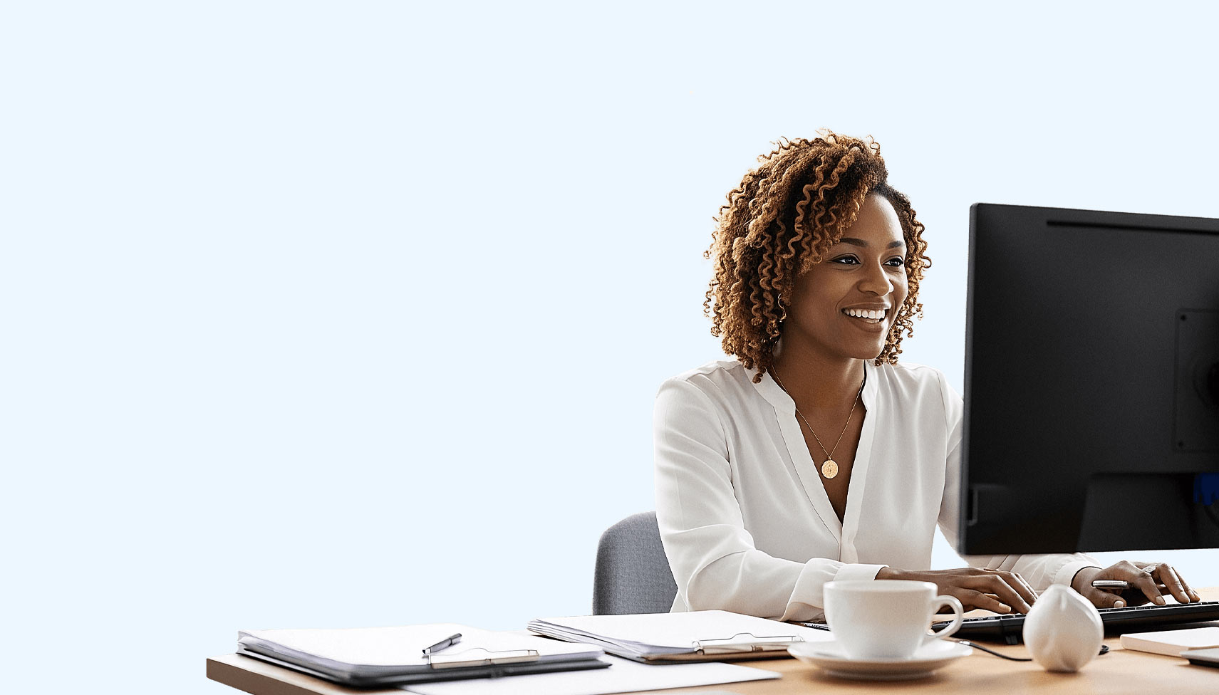 Eine Frau arbeitet mit SAP Business One DATEV Schnittstelle in einem Büro eines Mittelstand Unternehmens an einem PC